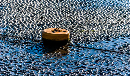 High angle view of buoy and rope at beach