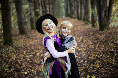 Happy halloween. funny kids brother and sister have fun in carnival costumes indoors.
