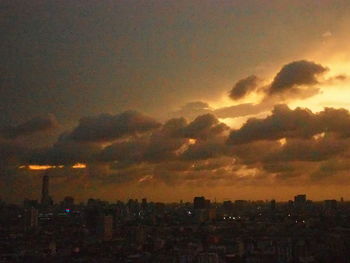 Silhouette cityscape against sky during sunset