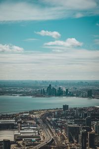 High angle view of cityscape and river against sky