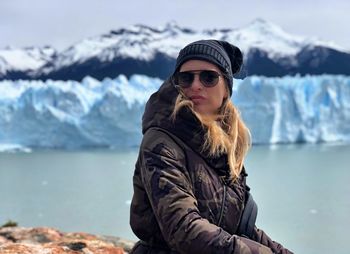 Mature woman wearing warm clothing by sea during winter