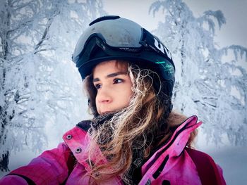 Close-up portrait of happy girl in snow