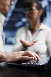 Midsection of woman using laptop