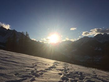 Scenic view of snowy landscape against sky during sunset