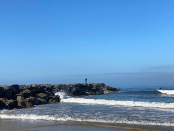 Scenic view of sea against clear blue sky