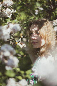 Close up sunlight shining through leaves on woman face portrait picture