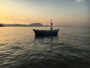 Sailboat on sea against sky during sunset