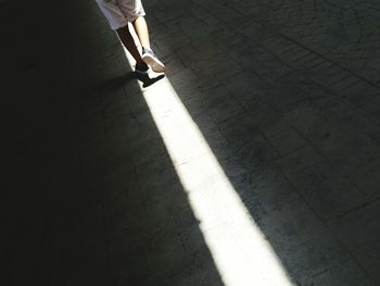 Low section of woman walking on zebra crossing