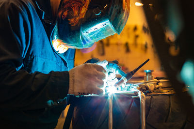 Manual worker working on metal in industry