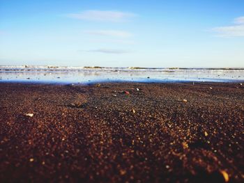 Surface level of beach against sky