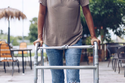 Midsection of man with woman standing on footpath