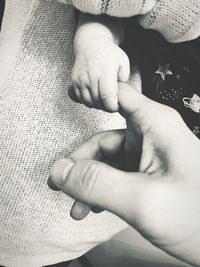 Close-up of baby hand on bed