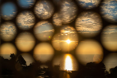 Close-up of illuminated water against sky during sunset