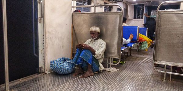 Full length of man sitting on seat