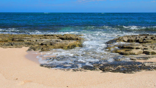 Scenic view of sea against blue sky