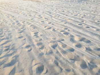 High angle view of tire tracks on sand