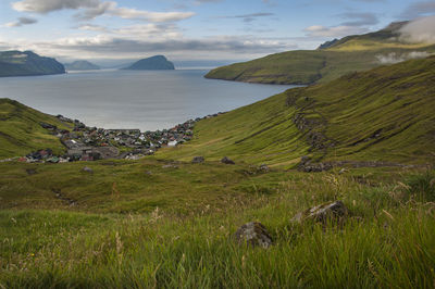Scenic view of sea and mountains against sky