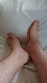 Low section of person legs on bed