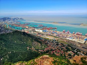 High angle view of buildings by sea against sky
