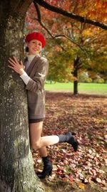 Portrait of cute girl standing on tree