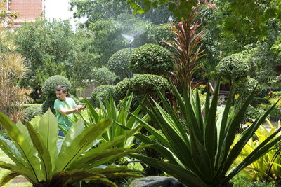 Woman amidst plants