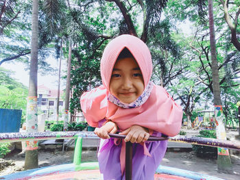 Portrait of smiling girl against pink trees