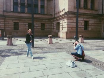 Full length of woman standing by railing