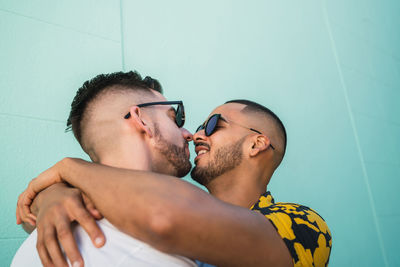 Gay couple embracing while standing outdoors