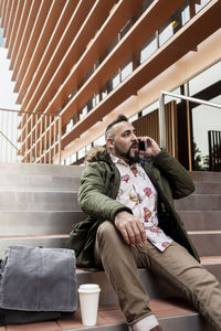 Handsome young man dressed casually spending time outdoors with