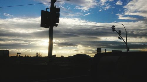 Road against cloudy sky at sunset