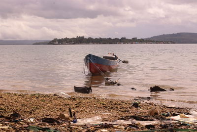 Boat on beach against sky