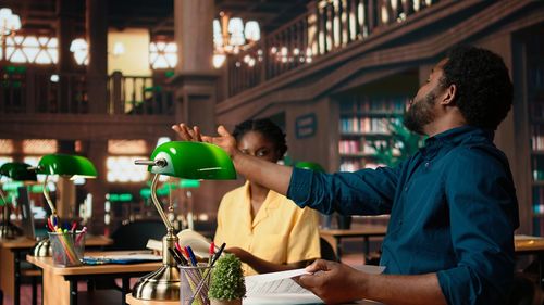 Rear view of man holding christmas tree