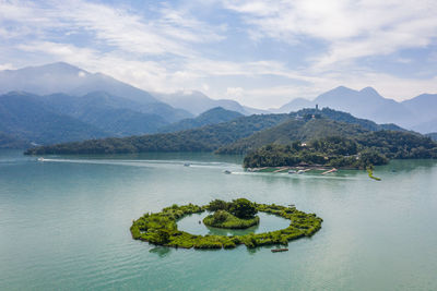 Scenic view of lake and mountains against sky