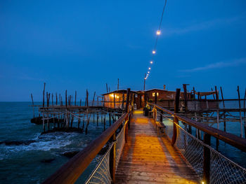 Pier over sea against clear sky