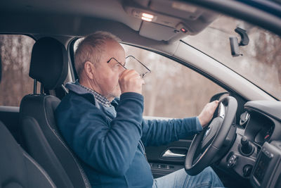 Midsection of man sitting in bus