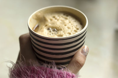 Close-up of hand holding coffee cup