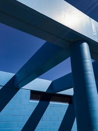 Low angle view of modern building against blue sky