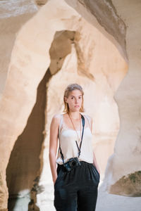 Portrait of young woman standing outdoors