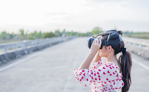 One young girls enjoy virtual reality glasses outdoor aalu.