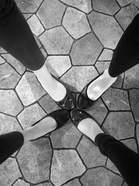 Low section of man standing on tiled floor