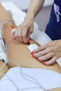 Midsection of woman lying on table