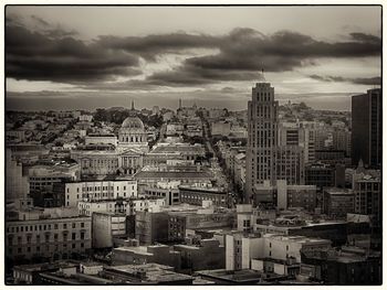 Cityscape against cloudy sky