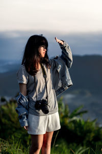 Woman standing against sky