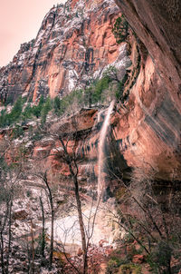 Low angle view of waterfall on rock formation