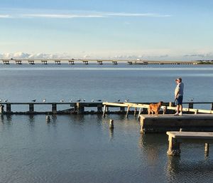 Man on bridge against sky