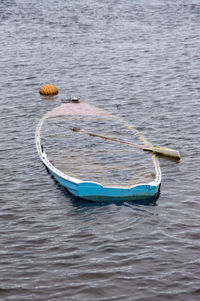 High angle view of abandoned boat with oar in lake