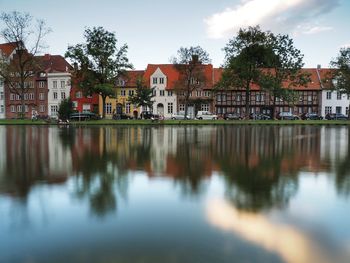 Reflection of buildings in lake against sky