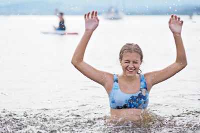 Portrait of happy girl enjoying in sea