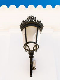 Low angle view of street light against building