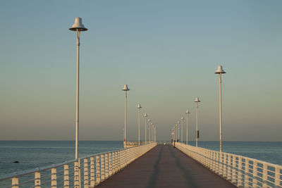 Pier over sea against clear sky